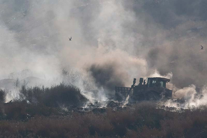 Bulldozers attempt to stamp out burning waste in the Vinča landfill in Belgrade, Serbia.