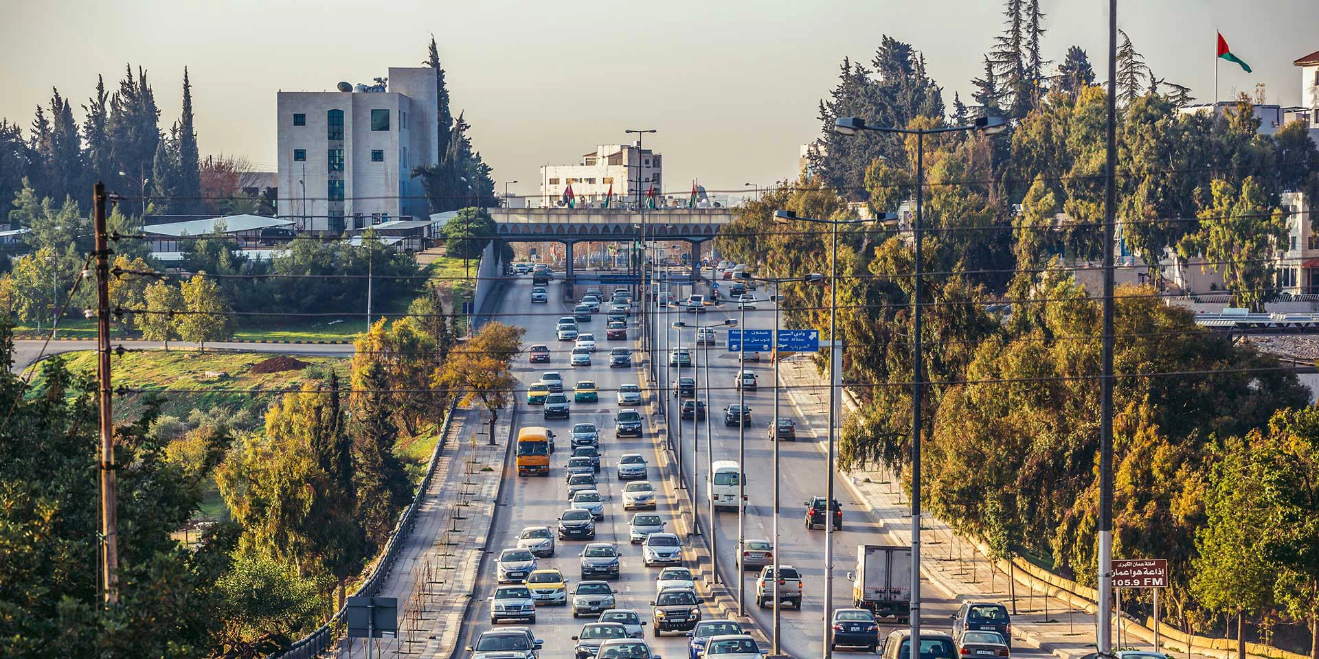 Urban road surrounded by trees.