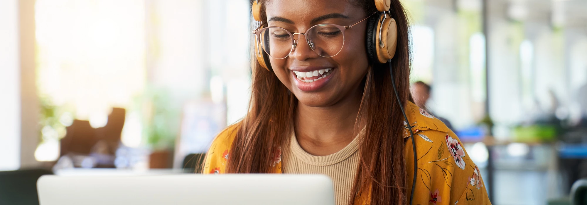 Young black African college girl studying online on her laptop. Close-up portrait happy woman.