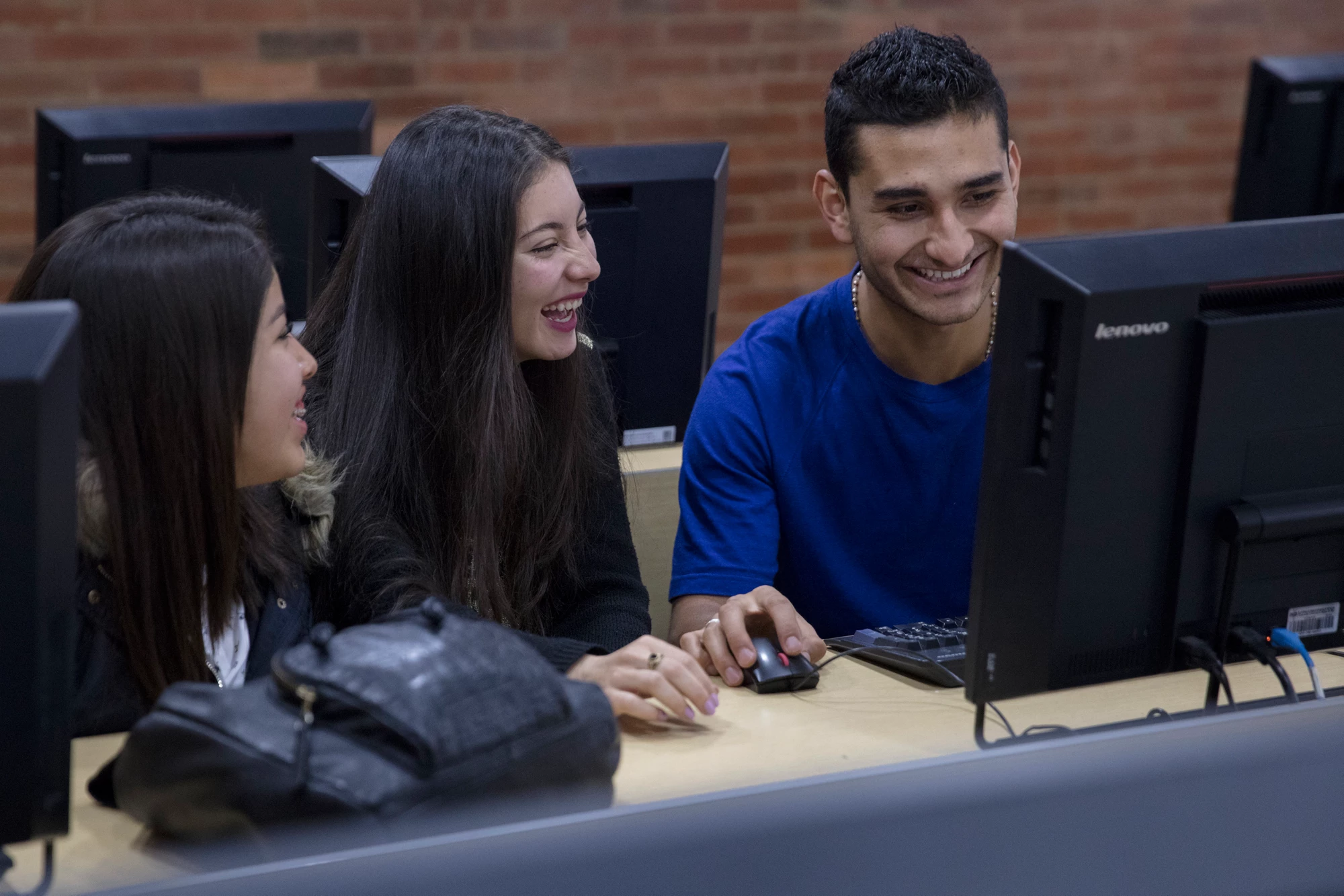 Students enjoying class exercises while learning about graphic design, at Uniminuto, a private university that serves low income students in Bogota, Colombia.